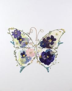 a butterfly made out of flowers on a white background