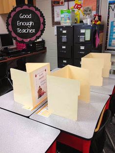 an empty classroom with desks, chairs and bookshelves on the tables in front of them