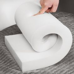 a person touching the top of a white object