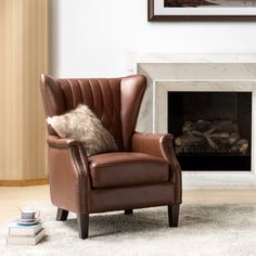 a brown leather chair sitting in front of a fire place with a pillow on it