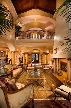 a living room filled with lots of furniture next to a stair case in a house