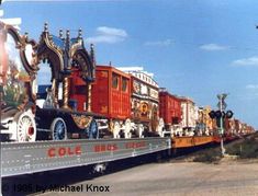 a large train traveling down tracks next to tall buildings