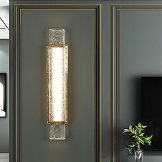 a modern style wall light in the corner of a living room with grey walls and flooring