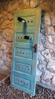 an old door with wine bottles on it