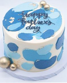 a birthday cake decorated with blue and gold confetti