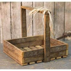 an old wooden crate with a bow tied to the handle and two pieces of wood in it