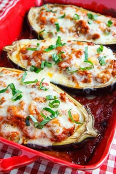 baked eggplant stuffed with meat and cheese in a red casserole dish