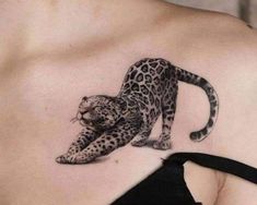 a woman's chest with a tattoo of a leopard on it