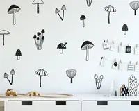 the wallpaper in this nursery room is decorated with black and white mushroom decals