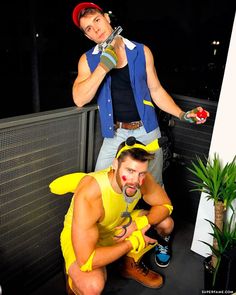 two men dressed in costumes posing for the camera