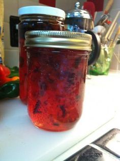 a jar filled with liquid sitting on top of a counter