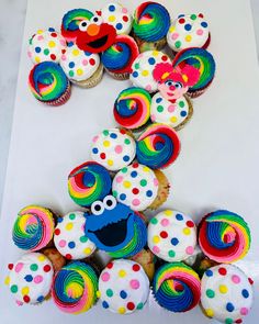 cupcakes and muffins are arranged in the shape of sesame street characters