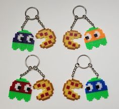 six pixel keychains are arranged in the shape of letters and numbers, each with different characters