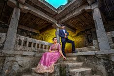 a man and woman sitting on some steps