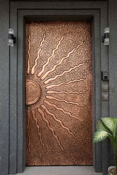 the door is made out of metal and has a decorative design on it's side