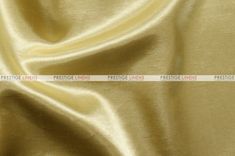 a plain gold satin fabric with an uneven design on the top and bottom, as well as