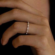 a woman's hand with a diamond ring on it