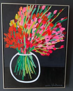 a painting of red and pink flowers in a white vase on a black background with gold trim