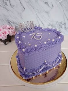 there is a purple cake with a crown on top