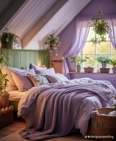 a bed in a bedroom with lavender colored sheets and blankets on top of the bedspread