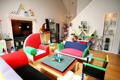 a living room filled with lots of colorful furniture