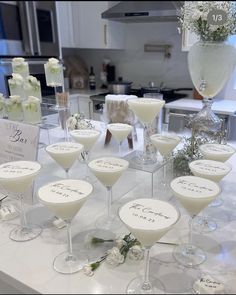 a table topped with lots of glasses filled with different types of drinks on top of it