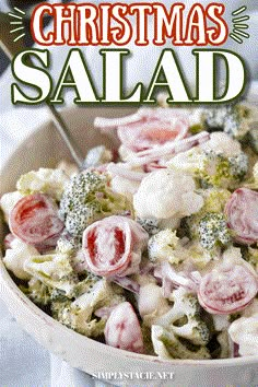 a bowl filled with broccoli, cauliflower and red onion salad next to a spoon