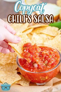 a person dipping salsa into a bowl with tortilla chips on the side and text overlay that reads copycat chili's salsa