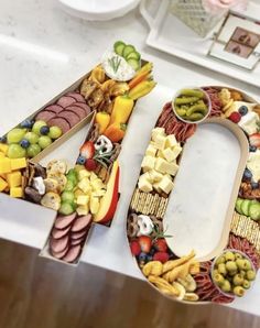 a number made out of fruits and vegetables sitting on top of a white countertop