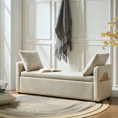 a living room with a white couch and rug