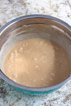 a metal bowl filled with liquid on top of a counter