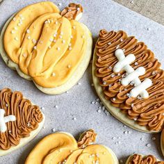 decorated cookies are arranged in the shape of footballs