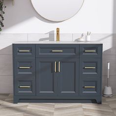 a bathroom vanity with gold handles and drawers