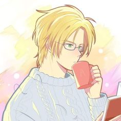 a man with glasses holding a coffee cup in front of his face and looking at a laptop