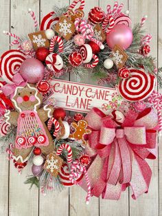 a christmas wreath with candy canes, gingerbread cookies and candies on it