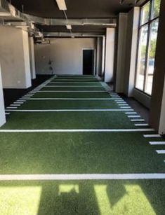 an empty office building with green carpet and white walls