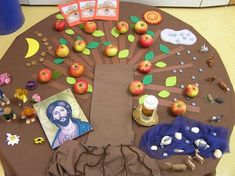 a table topped with pictures and toys on top of a brown cloth covered tablecloth