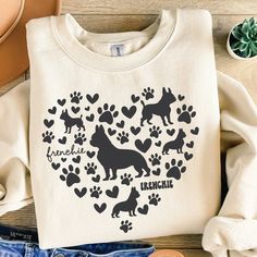 a white shirt with black dogs and hearts in the shape of a heart