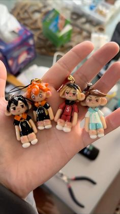 small figurines in the palm of someone's hand