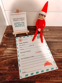 an elf is sitting on top of a piece of paper