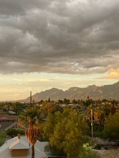 the sky is very cloudy and there are mountains in the background