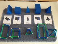 some blue and green objects are sitting on a gray mat with white squares around them