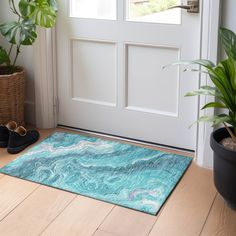 a pair of black slippers sitting on top of a blue rug next to a door