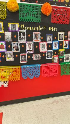 a bulletin board with pictures and decorations on it's side in a school hallway