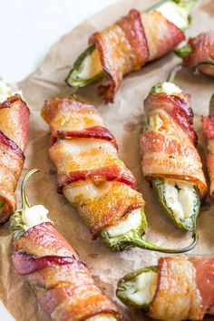 bacon wrapped jalapenos on a piece of parchment paper