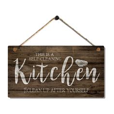 a wooden sign that says, this is a self - cleaning kitchen clean up after yourself