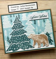 a card with an image of a bear and christmas trees on it, which reads winter wishes