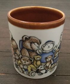 there is a coffee cup with teddy bears painted on the outside and inside it's rim