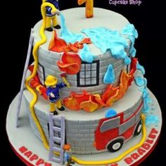 a birthday cake with fireman and ladders on it