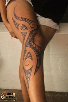 a woman's leg with an intricate tattoo design on the thigh and lower half